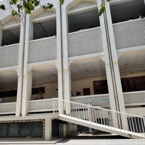 Courtroom interior, Lahore High Court Multan Bench, empty judge's bench, wooden paneling, stained glass windows, light streaming in, legal books, solemn atmosphere, justice, judiciary, institutional fragility.